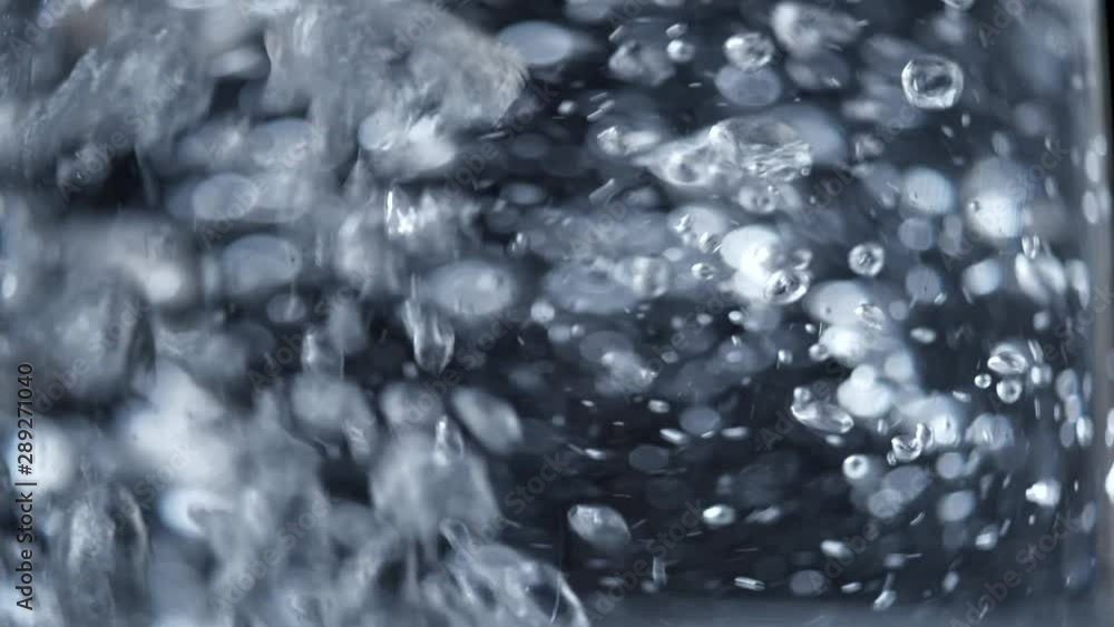 Slow motion shot of bubbles in boiling water Slow motion shot of bubbles in boiling water