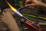 Glassblower. Glass on fire. The work of the master on a propane burner with hot glass.