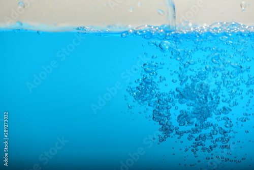 Blue water and air bubles on white background