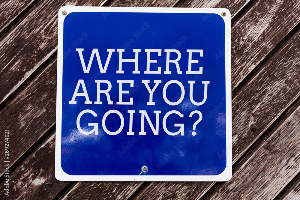 Handwriting text writing Where Are You Goingquestion. Conceptual photo used to ask someone the destination headed to Empty blue board with copy space above wooden background Handwriting text writing Where Are You Goingquestion. Conceptual photo used to ask someone the destination headed to Empty blue board with copy space above wooden background