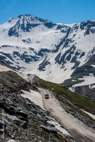 Vehical on the road to Rohtang pass in June photo