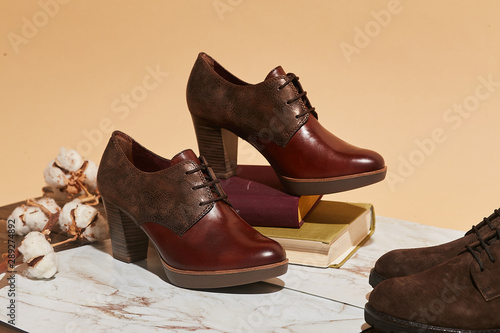 Stylish fashion shoes boots footwear concept on brown wooden background. Urban footwear advertising on wood