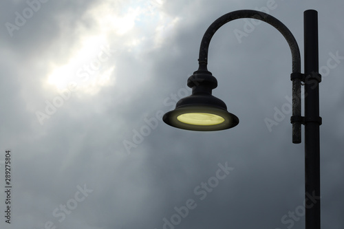 old style lamp on a cloudy sky photo