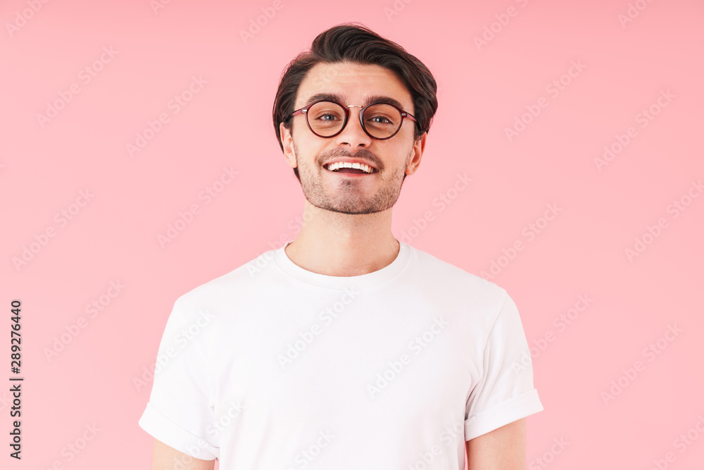 Image of handsome cheerful man wearing eyeglasses smiling and looking at camera