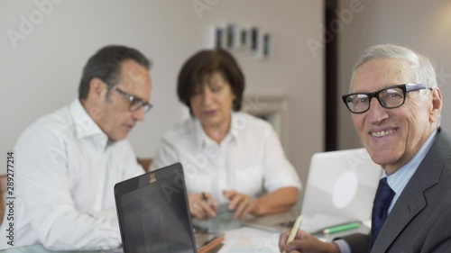 Wallpaper Mural Business team at work with graphs, digital tablet and laptop in a modern office. Teamwork with mature businessman manager leader and CEO. Business leader. Torontodigital.ca