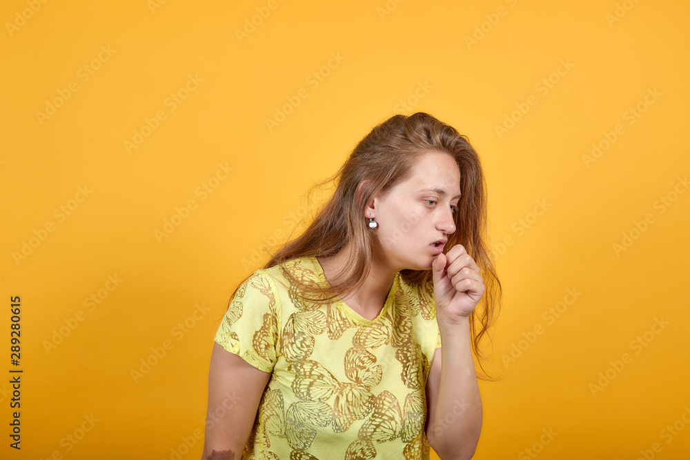brunette girl in yellow t-shirt over isolated orange background shows emotions brunette girl in yellow t-shirt over isolated orange background shows emotions