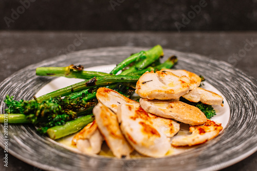 plate of grilled turkey fillet with bimi broccoli. photo