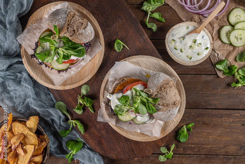 Healthy vegan burger with fresh vegetables and yogurt sauce Healthy vegan burger with fresh vegetables and yogurt sauce