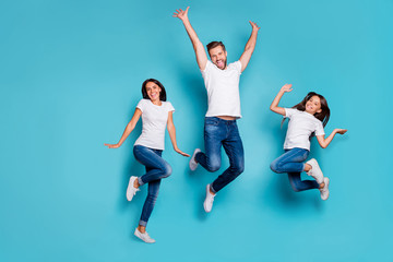 Full length body size photo of jumping enjoying nice glad family cute wearing white t-shirts jeans denim while isolated with blue background