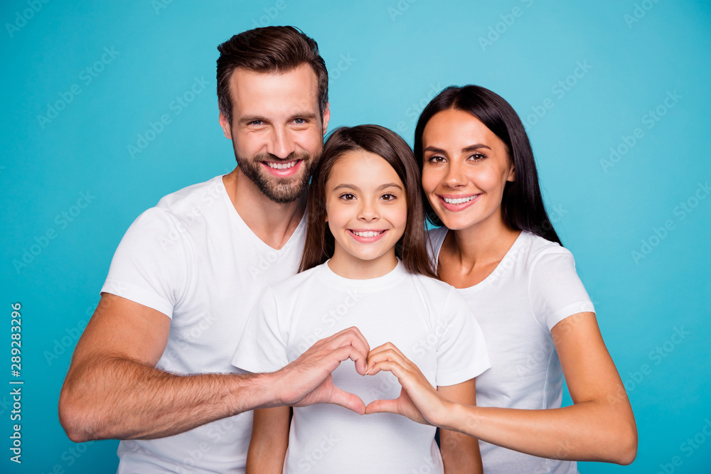 Photo of adopted family taking care of little daughter show heart figure wear casual outfit isolated blue background Photo of adopted family taking care of little daughter show heart figure wear casual outfit isolated blue background