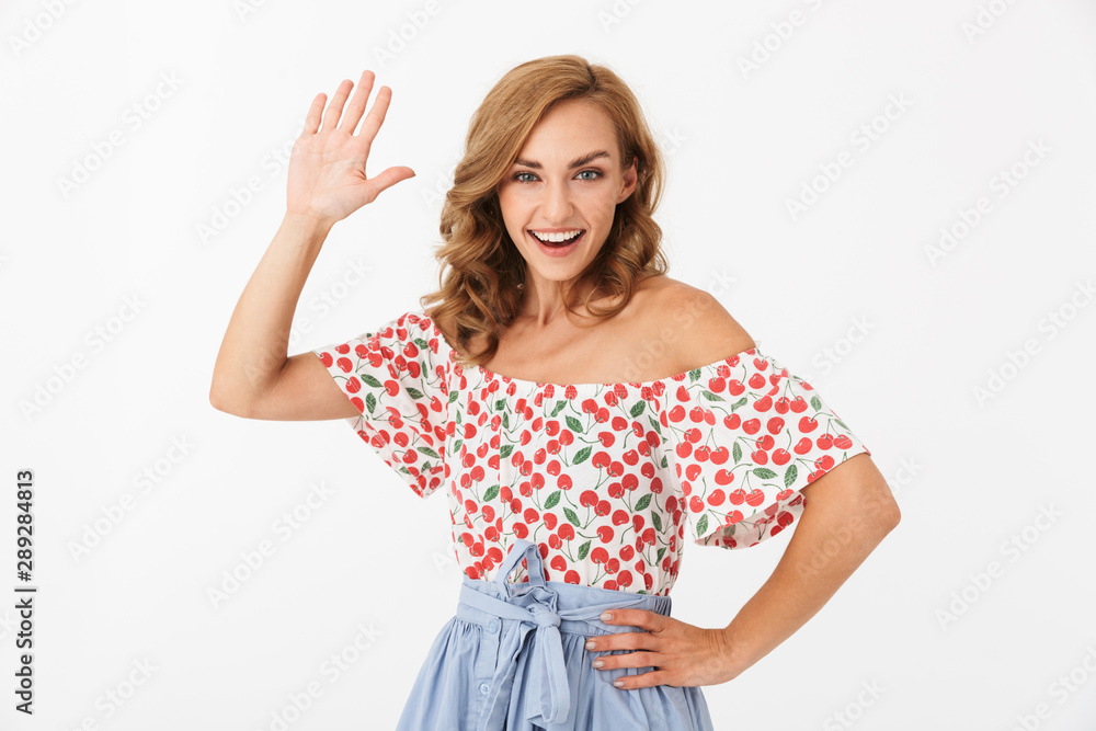 Portrait of seductive joyful woman wearing summer clothes giving high five and smiling Portrait of seductive joyful woman wearing summer clothes giving high five and smiling