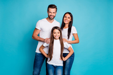 Portrait of charming family smiling wearing white t-shirt isolated over blue background
