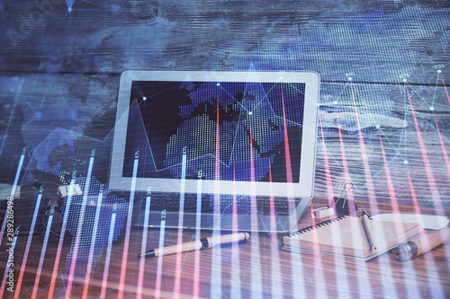 Financial graph colorful drawing and table with computer on background. Double exposure. Concept of international markets. © peshkova