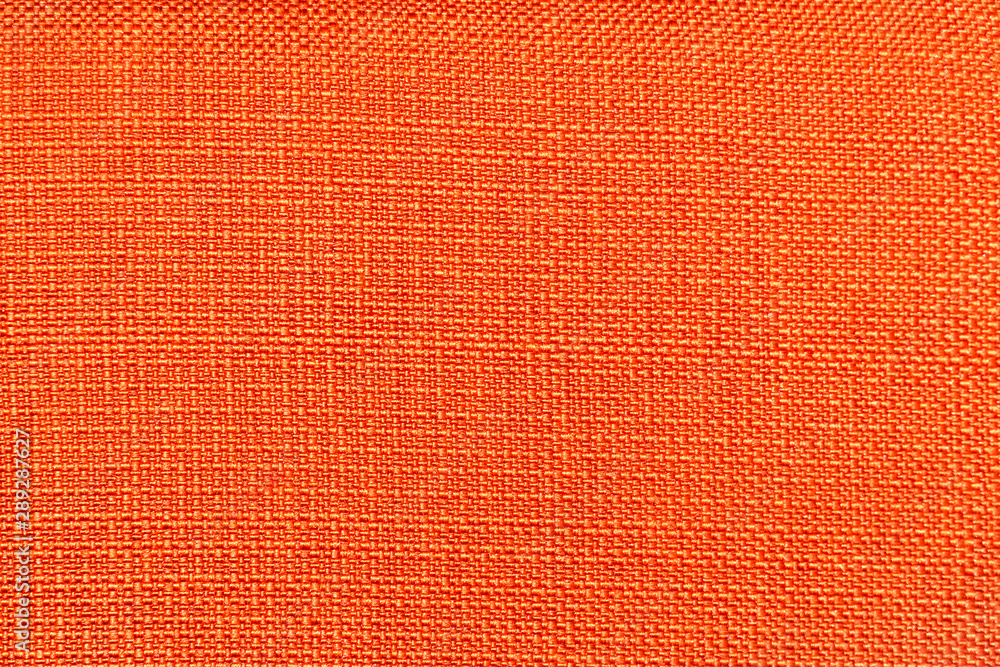 Fototapeta premium Rough bright orange fabric texture for background and design