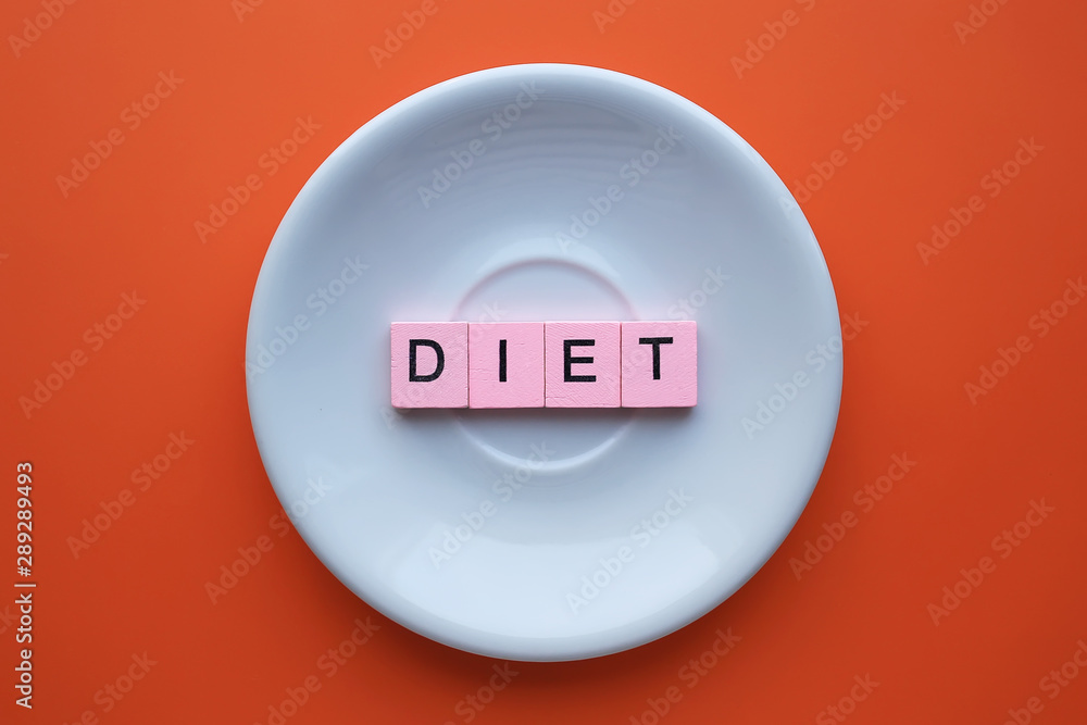 Diet word wooden cubes on orange background. Health concept Diet word wooden cubes on orange background. Health concept
