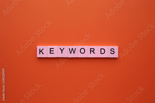 Keywords word wooden cubes on an orange background. photo