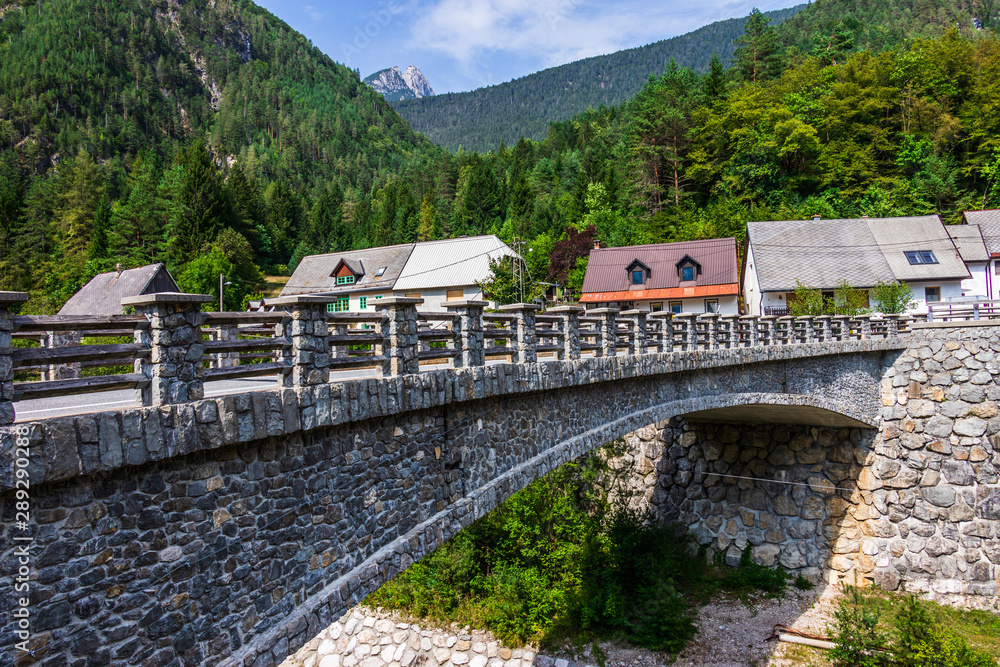 Bridge over River Predelica from Predil Pass in Village Log pod Mangartom. Bovec, Slovenia, Europe.