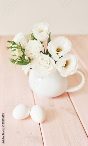 Easter flowers and eggs. Festive Easter spring composition with flowers and eggs. Easter Background. Springtime. Invitation card design with copy space. Easter card template