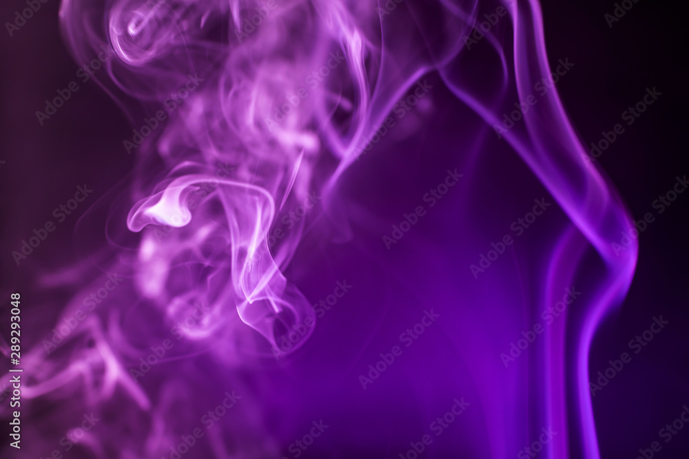 Smoke on a dark background in a bright trendy purple neon light. Minimalistic background concept. Smoke on a dark background in a bright trendy purple neon light. Minimalistic background concept.