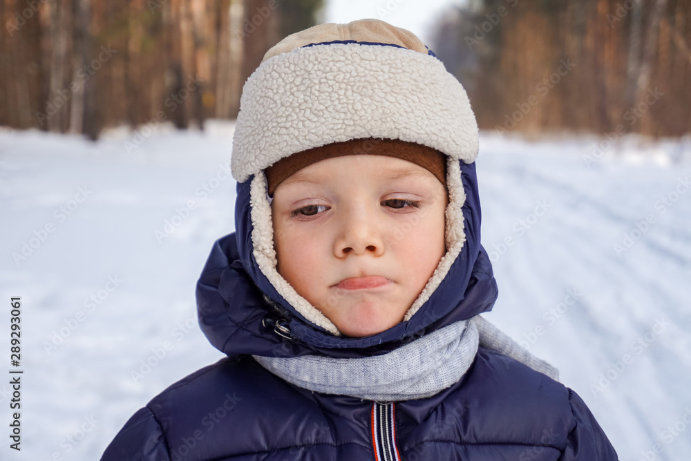 close up portrait of a happy child boy throws snow, snowflakes in the air in cold winter against the background of snowdrifts close up portrait of a happy child boy throws snow, snowflakes in the air in cold winter against the background of snowdrifts