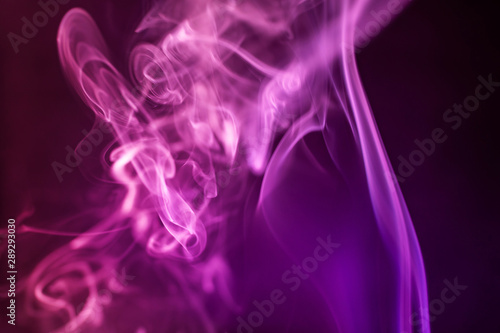 Smoke on a dark background in a bright trendy pink neon light. Minimalistic background concept.