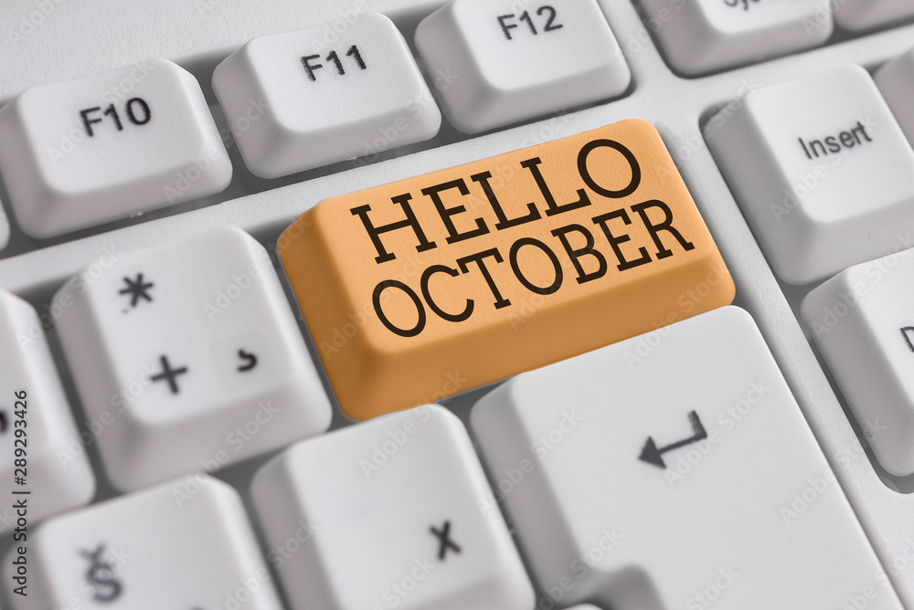 Conceptual hand writing showing Hello October. Concept meaning Last Quarter Tenth Month 30days Season Greeting White pc keyboard with note paper above the white background Conceptual hand writing showing Hello October. Concept meaning Last Quarter Tenth Month 30days Season Greeting White pc keyboard with note paper above the white background