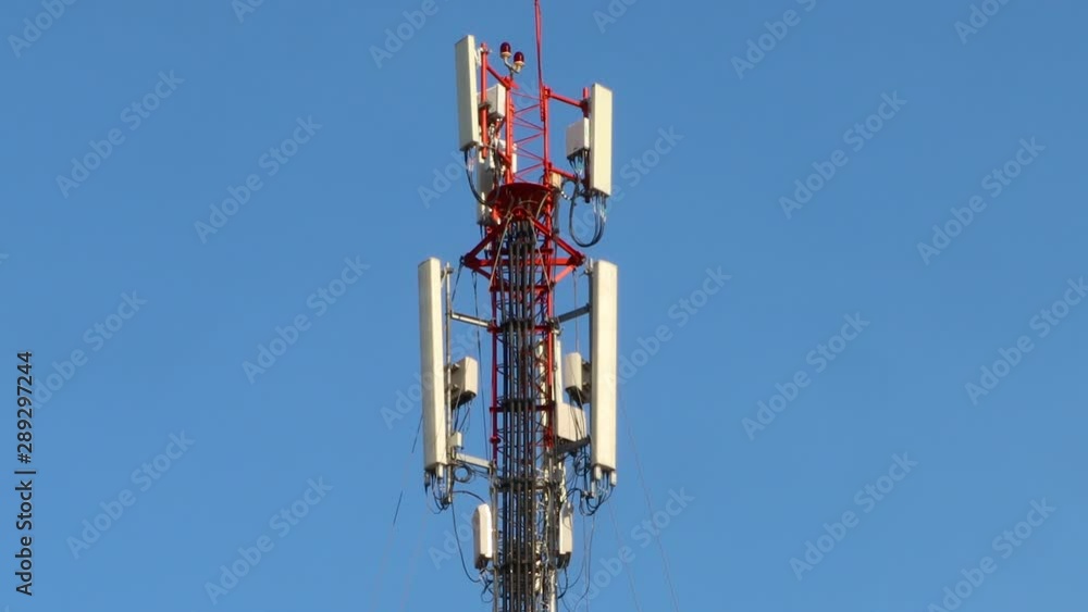 Communications Tower Against a Blue Sky. TILT UP, REAL TIME Communications Tower Against a Blue Sky. TILT UP, REAL TIME