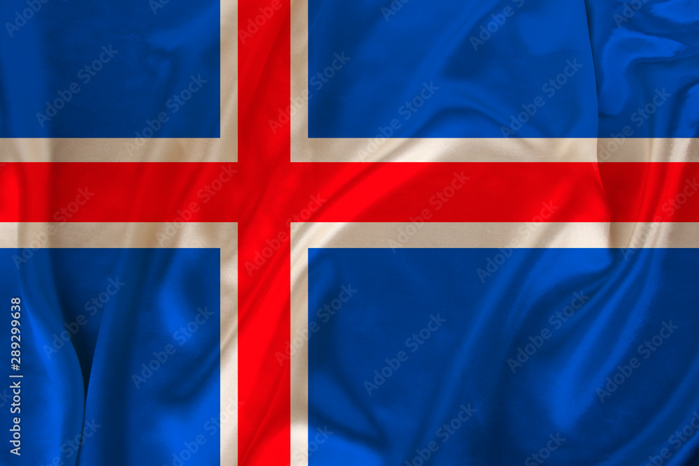 Fototapeta premium photo of iceland state national flag on luxurious texture of satin, silk with waves, folds and highlights, closeup, copy space, illustration