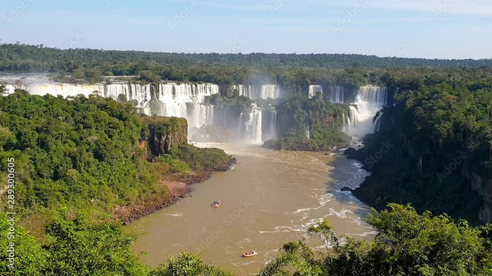 Iguazu waterfalls on a sunny day with a boat Iguazu waterfalls on a sunny day with a boat