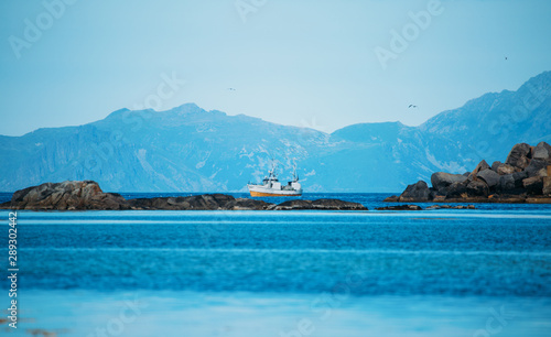 Photo of ship, hills, sea, sky in Norway on summer.