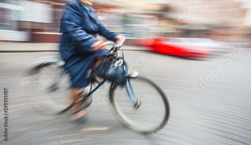 old woman cyclist on the city roadway