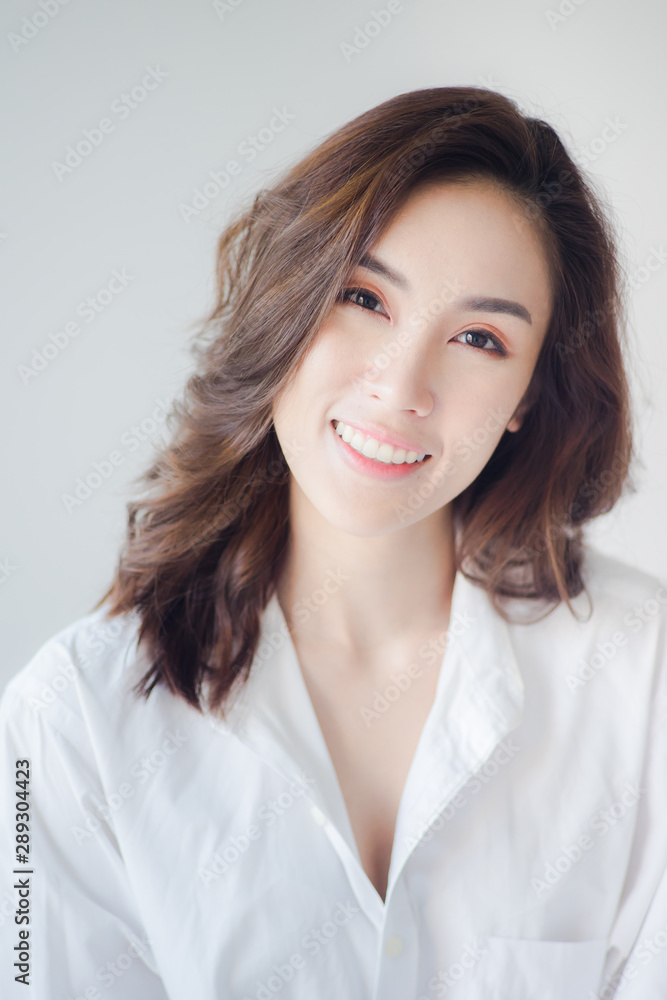 Beautiful smiling woman wearing a white shirt with clean skin, natural make-up Beautiful smiling woman wearing a white shirt with clean skin, natural make-up