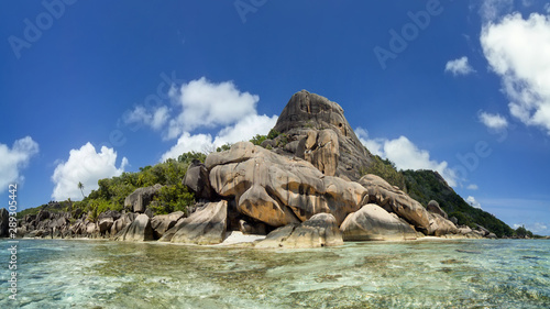 Bizarre rocks on the shore of La Digue island at high tide  Seychelles