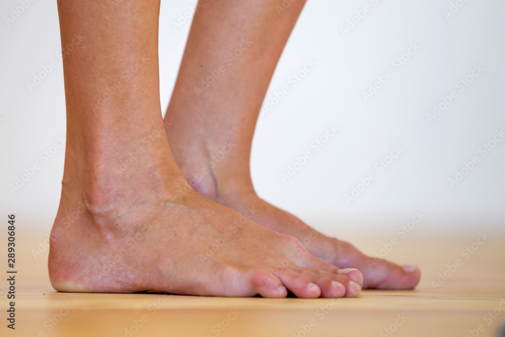 Woman bare feet on the floor. Legs care and skin treatment concept. Woman bare feet on the floor. Legs care and skin treatment concept.