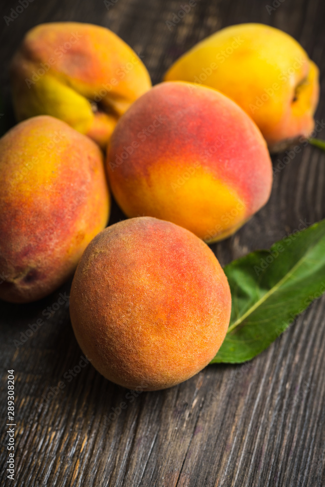 Sweet ripe peaches on the rustic background. Selective focus. Shallow depth of field. Sweet ripe peaches on the rustic background. Selective focus. Shallow depth of field.