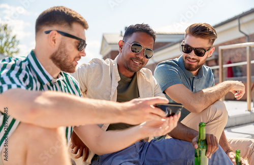 Photography leisure, technology and people concept - happy male friends with smartphone drin
