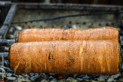 Preparation of the famous, traditional and delicious Hungarian Chimney Cake Kurtos Kolacs (Kürtőskalács) photo