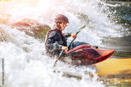 Fototapeta Naklejka Na Ścianę i Meble -  Guy in kayak sails mountain river. Whitewater kayaking, extreme sport rafting