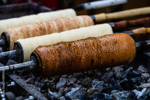 Preparation of the famous, traditional and delicious Hungarian Chimney Cake Kurtos Kolacs (Kürtőskalács) photo