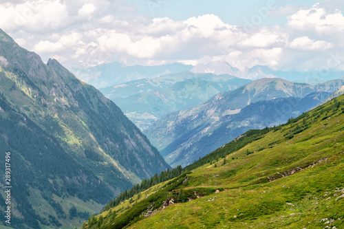 Panorama of picturesque blue mountainsides and green alpine meadows, Austria © natagolubnycha