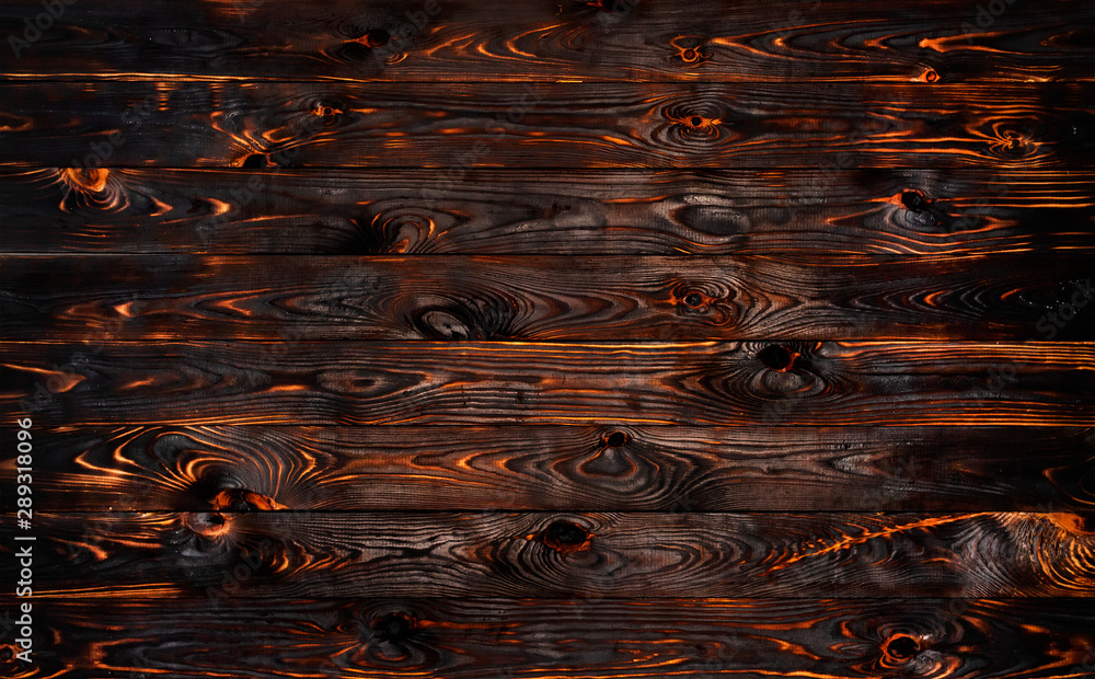 Fototapeta Burnt wooden board, black charcoal wood texture, burned barbecue background