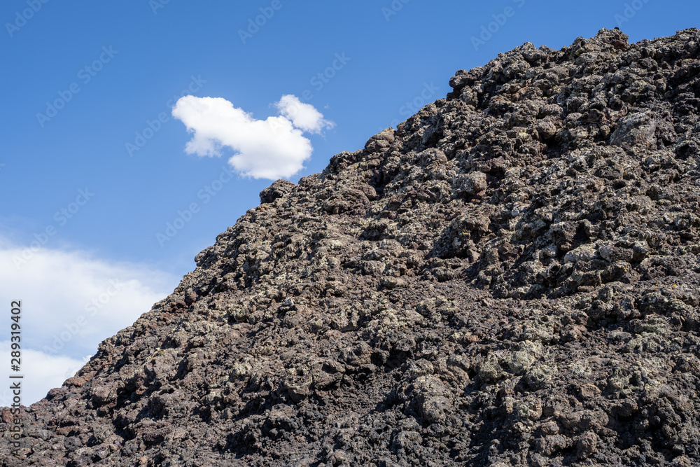 Craters of the Moon National Monument - black lava rock against blue sky Craters of the Moon National Monument - black lava rock against blue sky