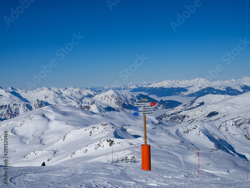 LES MENUIRES, FRANCE - February 2018: Directions pointer on a top of mountain in ski resort "3 valleys"