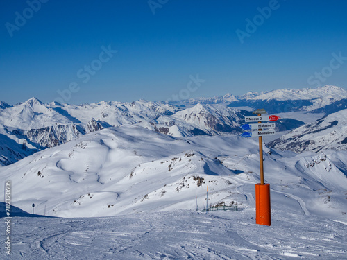 LES MENUIRES, FRANCE - February 2018: Directions pointer on a top of mountain in ski resort 