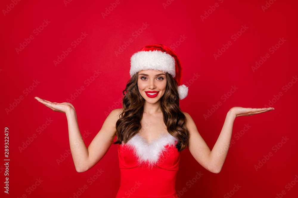 Portrait of pretty woman with curly long hairstyle holding hands recommend ads wearing stylish skirt dress isolated over red background Portrait of pretty woman with curly long hairstyle holding hands recommend ads wearing stylish skirt dress isolated over red background