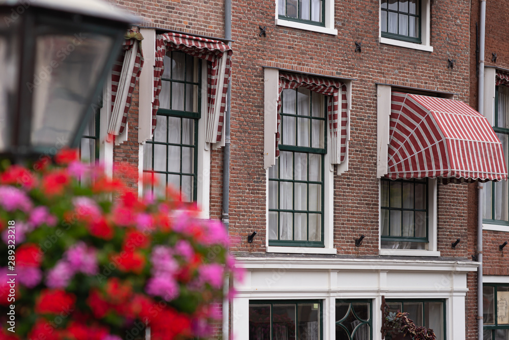 Traditional Dutch houses near canal in a beautiful sunny day