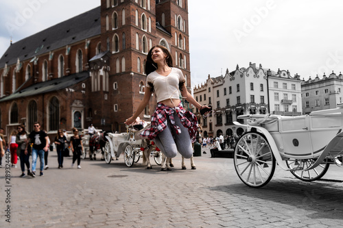 Wallpaper Mural Young happy girl in casual clothes bounced in the old city center, street photo Torontodigital.ca