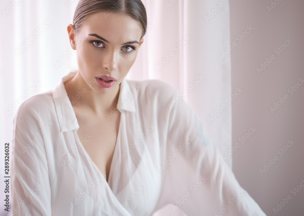 Amazing Blue eyed blond woman smiling to camera. Indoor portrait Amazing Blue eyed blond woman smiling to camera. Indoor portrait