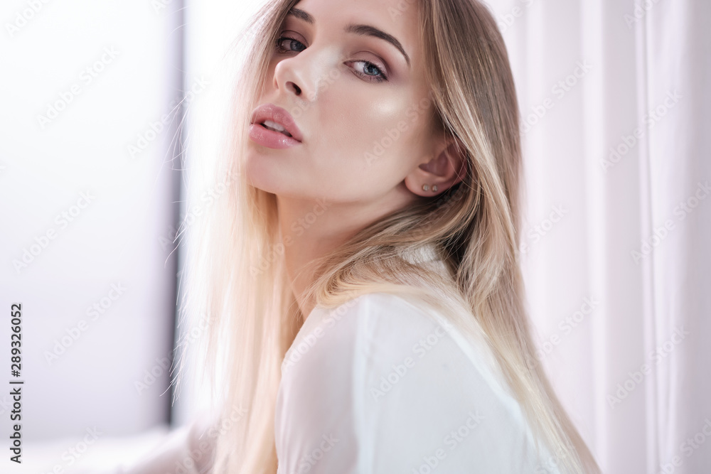 Amazing Blue eyed blond woman smiling to camera. Indoor portrait Amazing Blue eyed blond woman smiling to camera. Indoor portrait