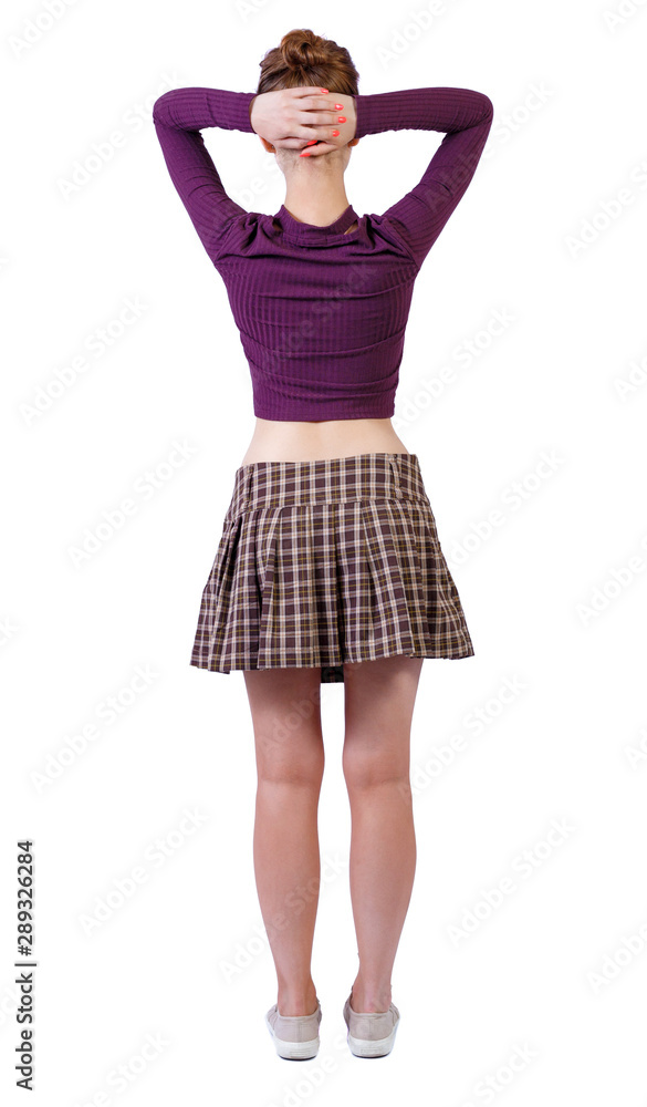 Naklejka premium back view of standing young beautiful woman.